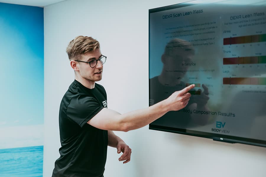 Adam explaining DEXA scan report on lean mass