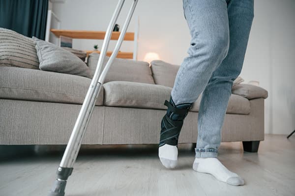 An image of the dangers of low bone density show a person with a fractured ankle