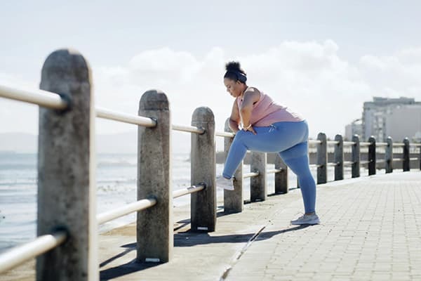 A person stretching on a sea front