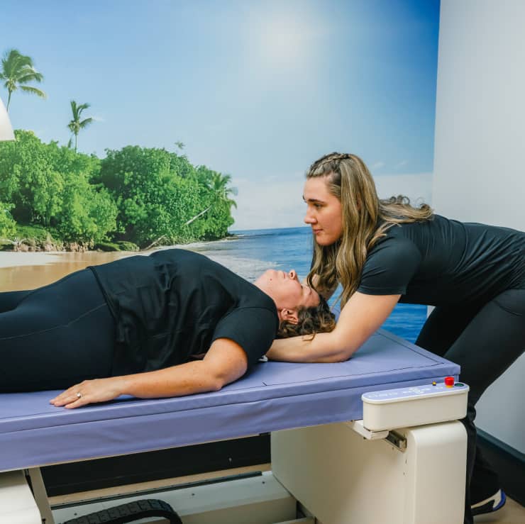 Technician assisting patient on DEXA scanner